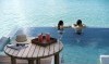 AVEL__Overwater_Pool_Suite_lifestyle_couple_G_A_H_P.jpg